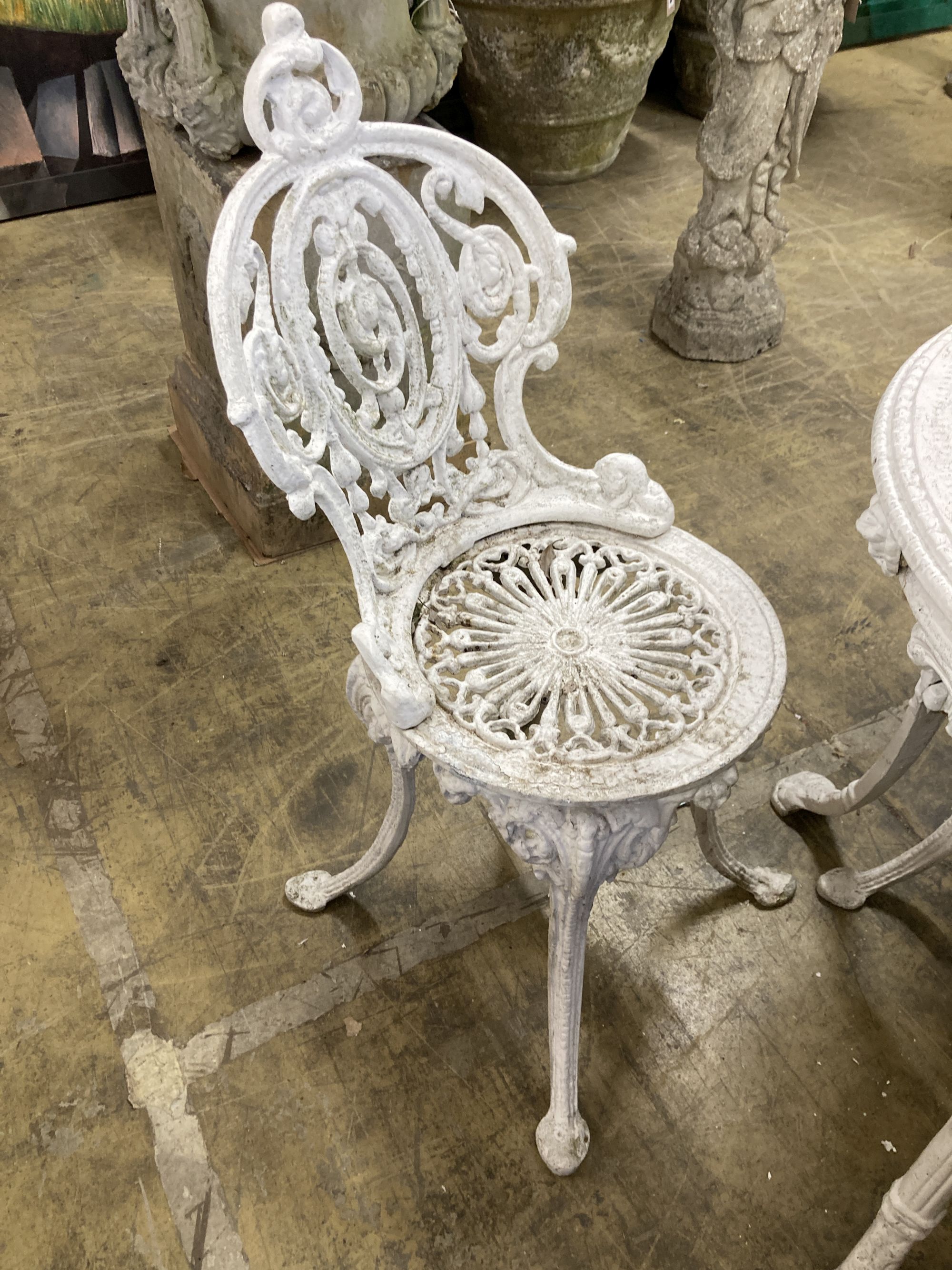 A Coalbrookdale style painted aluminium garden table, 59cm diameter, height 72cm and two chairs